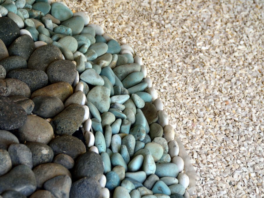 Pebbles and stones, with their different colors, textures, and sizes, can add interesting contrasts to the garden.